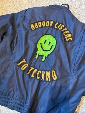 Vintage “Nobody Listens to Techno” Club Jacket with Green Smiley